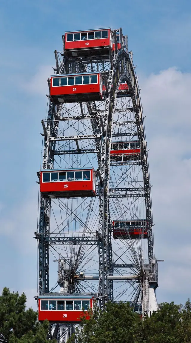 Historic Giant Ferris Wheel with red cabins at Vienna Prater