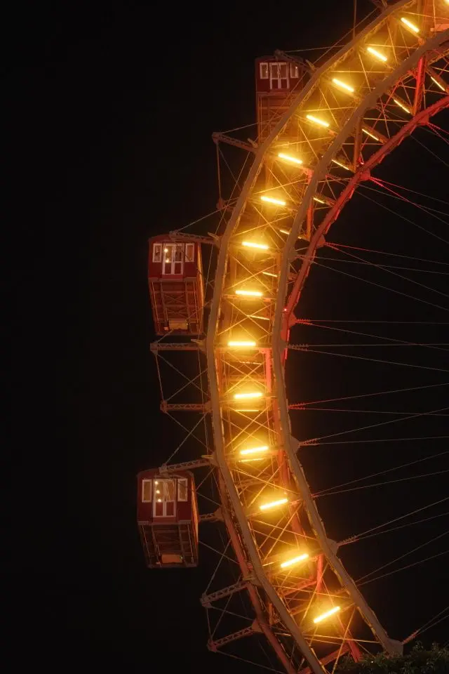 Giant Ferris Wheel illuminated at night at Vienna Prater