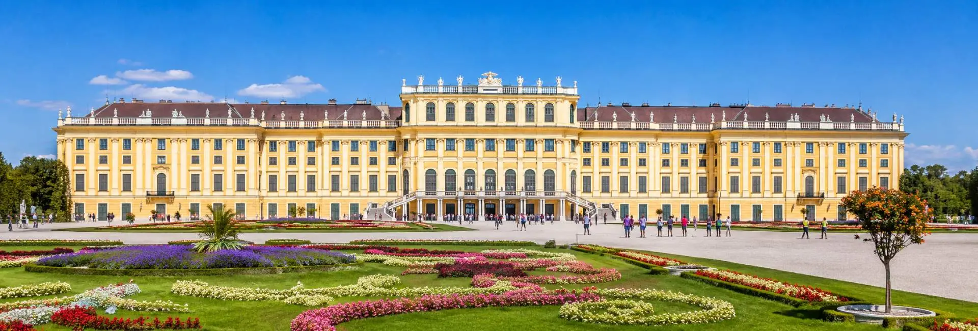 Schönbrunn Palace in Vienna with its grand Baroque façade and colorful formal gardens
