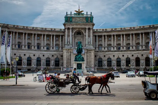 Hofburg Palace in Vienna with horse-drawn carriages in front