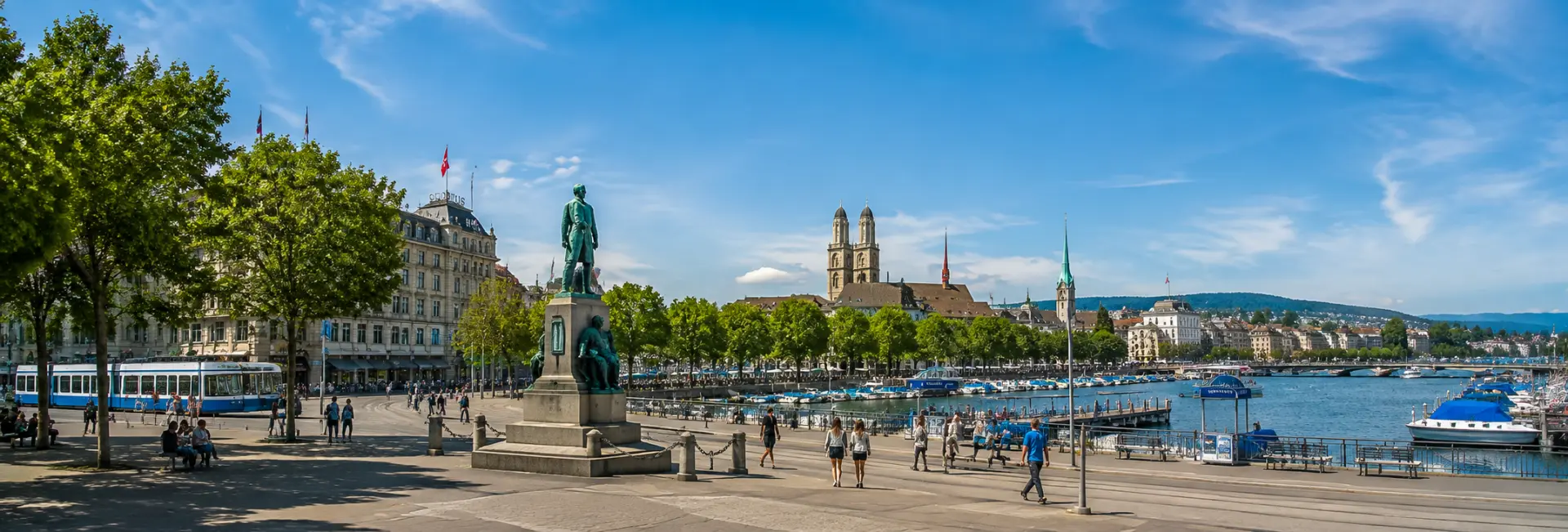 Bürkliplatz in Zurich with Lake Zurich, boats, trams, and the city skyline