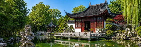 Chinese Garden Zürich with a traditional pavilion, koi pond, stone bridge, and lush greenery