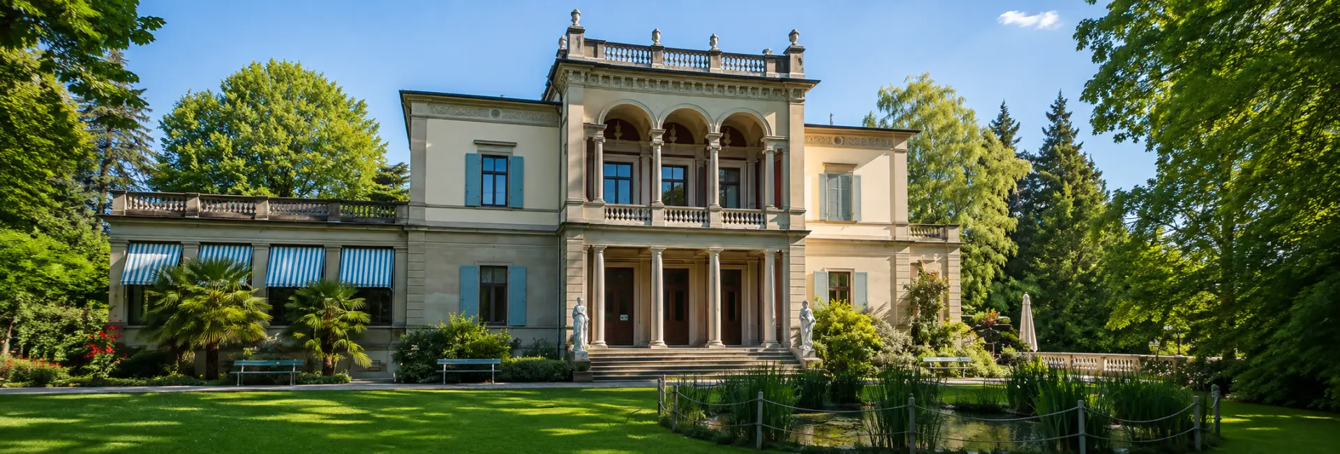 Rietberg Museum in Zurich surrounded by lush gardens and a tranquil pond