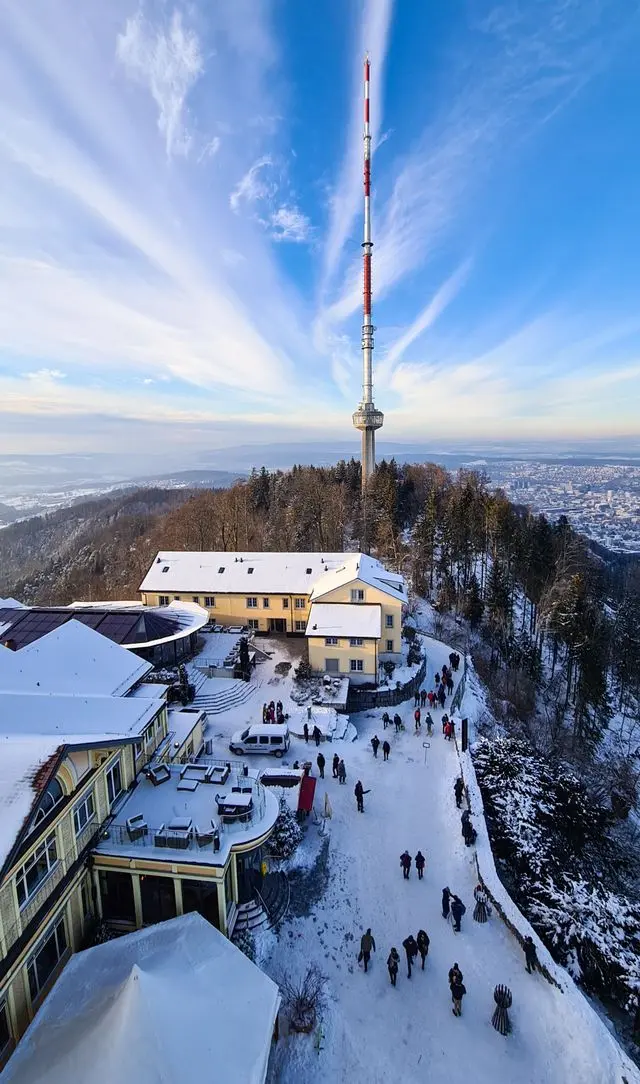 Snow-covered Uetliberg Mountain with its iconic radio tower above Zurich