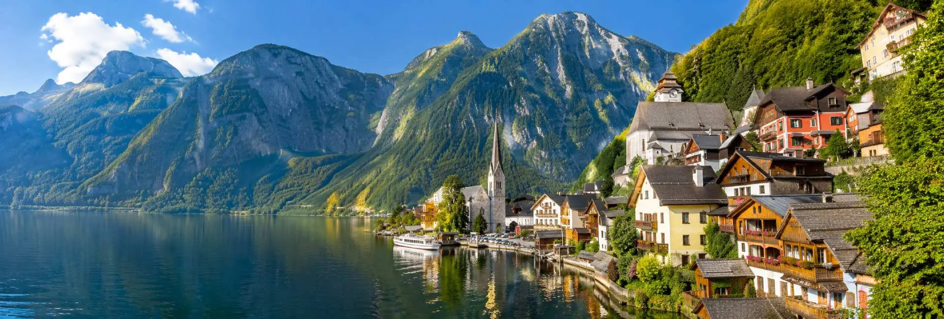 Hallstatt Austria village beside Lake Hallstatt with dramatic Alpine mountains