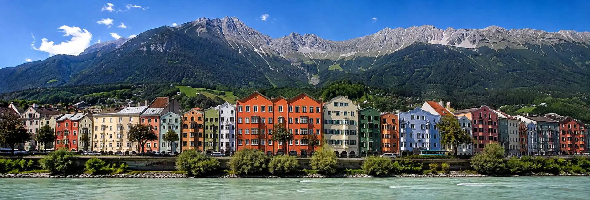 Innsbruck Austria with colorful riverside buildings and the dramatic Nordkette mountains