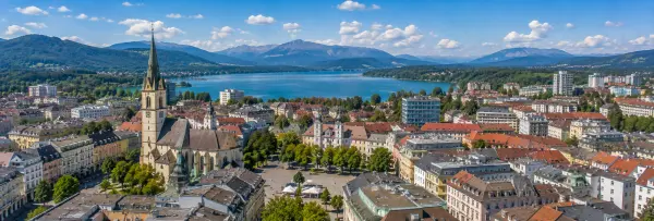 Klagenfurt, Austria panoramic cityscape with lake and Alps