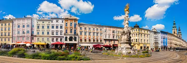 Linz, Austria historic square with colorful buildings and the Trinity Column