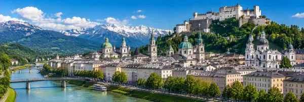 Salzburg Austria cityscape with Hohensalzburg Fortress, Salzach River and Alpine mountains