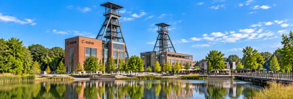 Genk, Belgium C-mine with historic mining headframes and red-brick industrial buildings