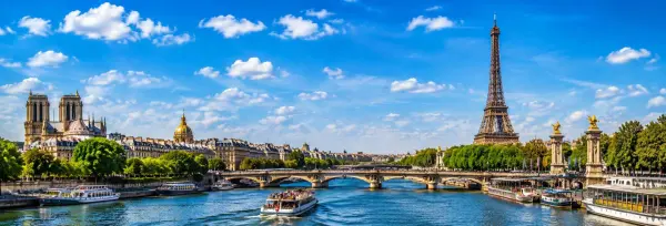 Eiffel Tower overlooking the Seine River on a bright sunny day in Paris