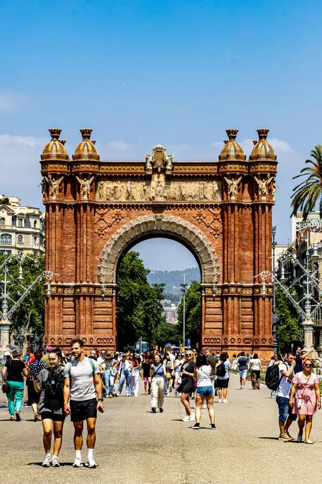 Arc de Triomf with visitors walking along the promenade in Barcelona