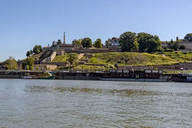 Belgrade Fortress in Serbia, featuring historic stone fortifications and green hills overlooking the Sava River.