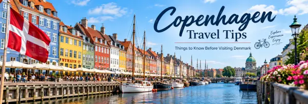 Colorful Nyhavn waterfront in Copenhagen with boats, cafés and Danish flags