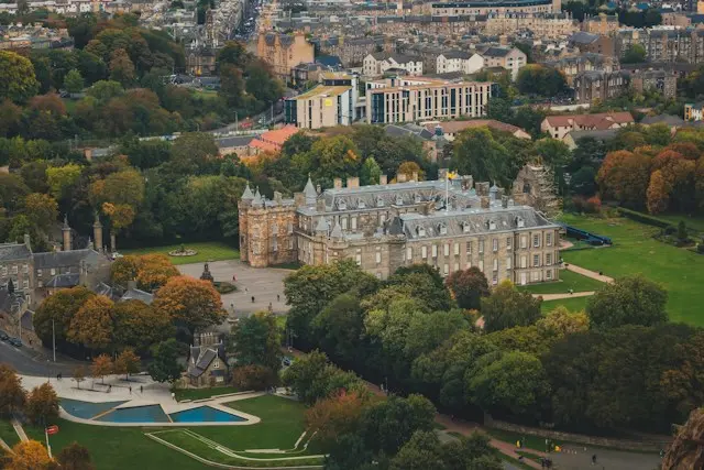 Holyrood Palace surrounded by gardens and trees in Edinburgh