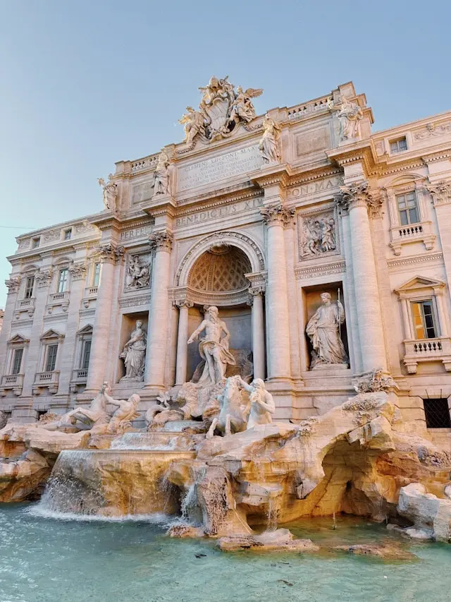 Trevi Fountain with its ornate Baroque sculptures and cascading turquoise water in Rome.