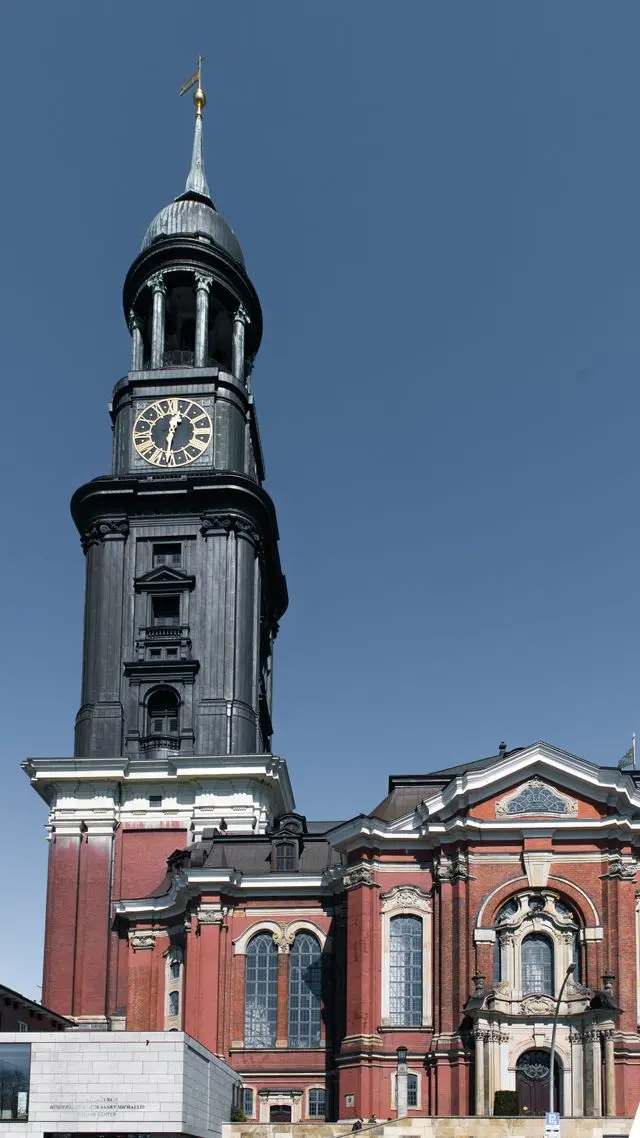 Historic red-brick building with an ornate clock tower in Hamburg, Germany.