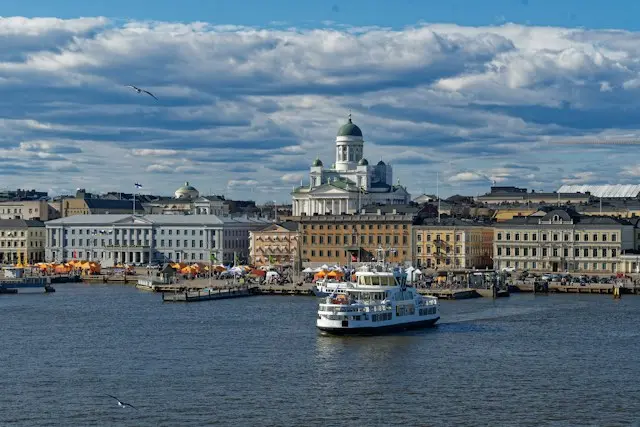 Helsinki Cathedral overlooking the waterfront, with a passenger ferry crossing the harbour.
