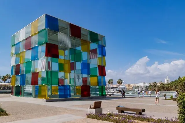 Centre Pompidou Málaga featuring a colorful glass cube with vibrant panels near the city's waterfront.