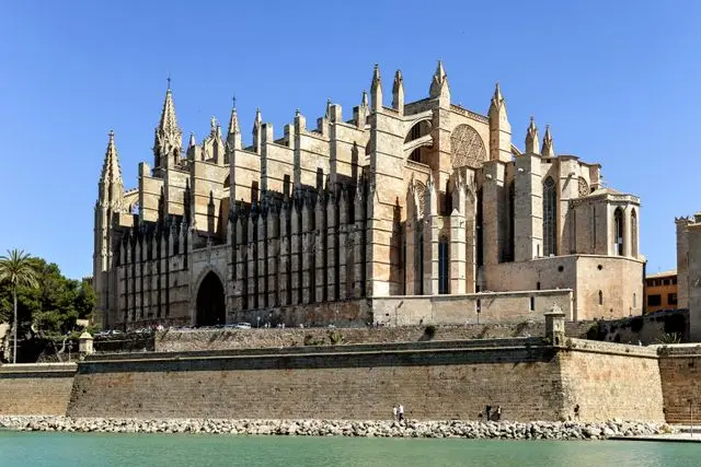Palma Cathedral in Mallorca, Spain, featuring magnificent Gothic architecture, towering spires, and a waterfront setting