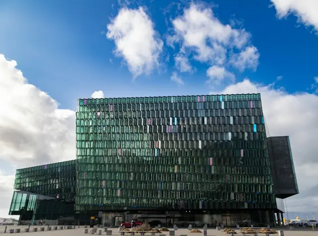 Harpa Concert Hall with colorful glass panels under a blue sky in Reykjavik