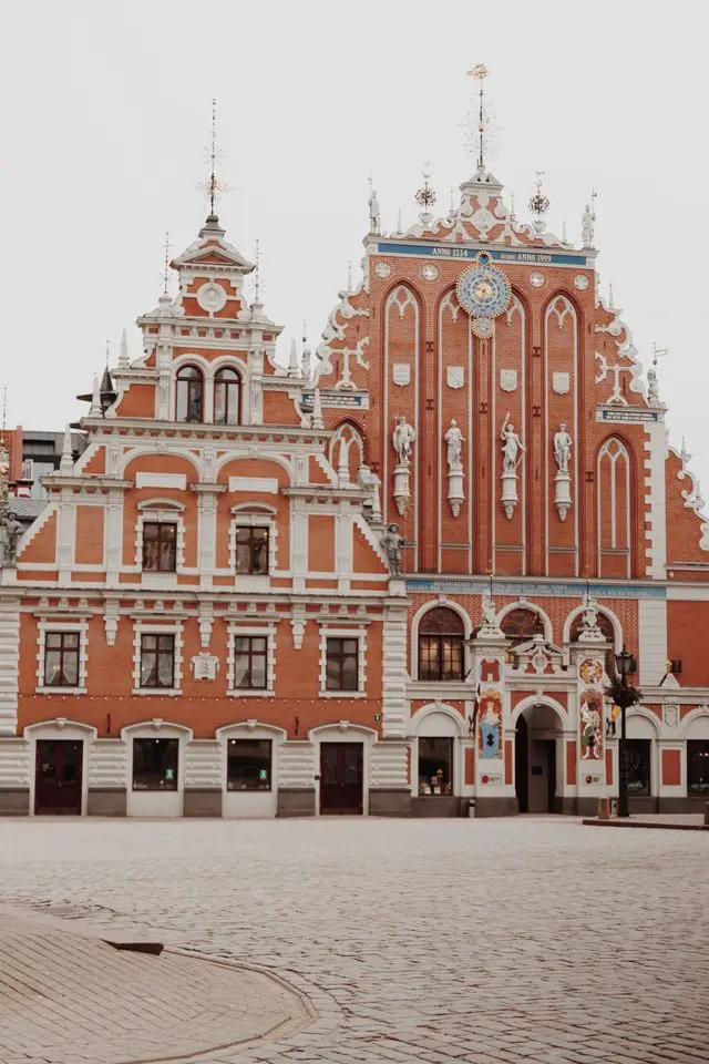 House of the Blackheads in Riga, Latvia, featuring an ornate red-brick facade, decorative sculptures, and Gothic details