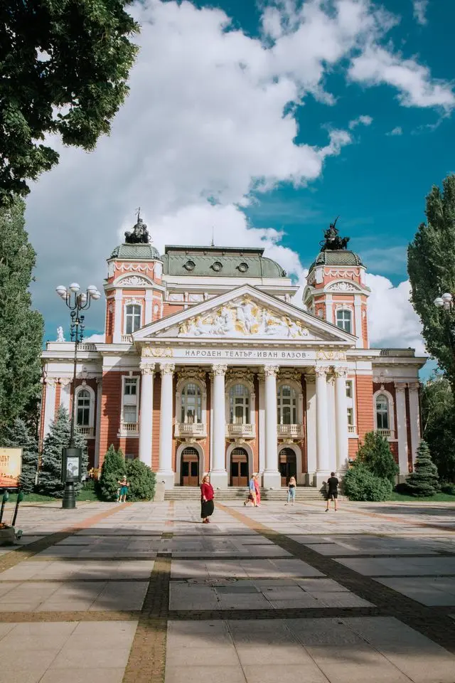Ivan Vazov National Theatre in Sofia, Bulgaria, featuring grand columns, ornate sculptures, and a neoclassical facade.