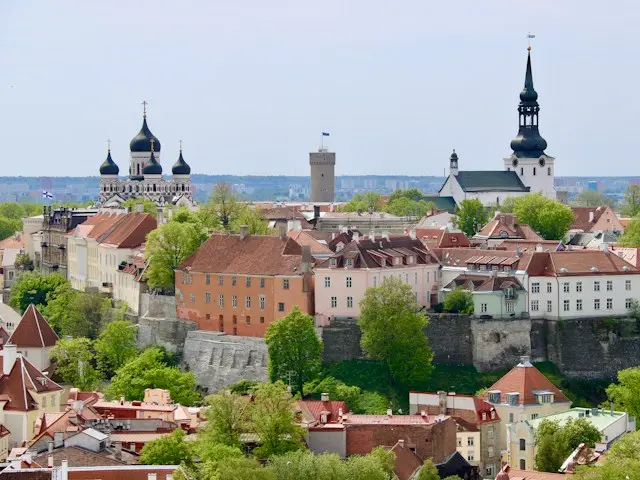 Panoramic view of Tallinn Old Town, Estonia, featuring medieval towers, church spires, and red-roofed buildings.