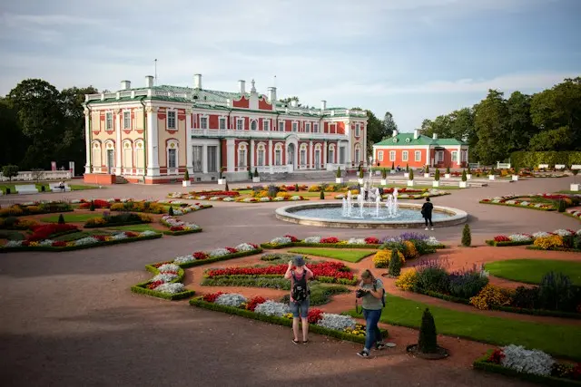 Kadriorg Palace in Tallinn, Estonia, surrounded by colorful flower gardens and a central fountain.