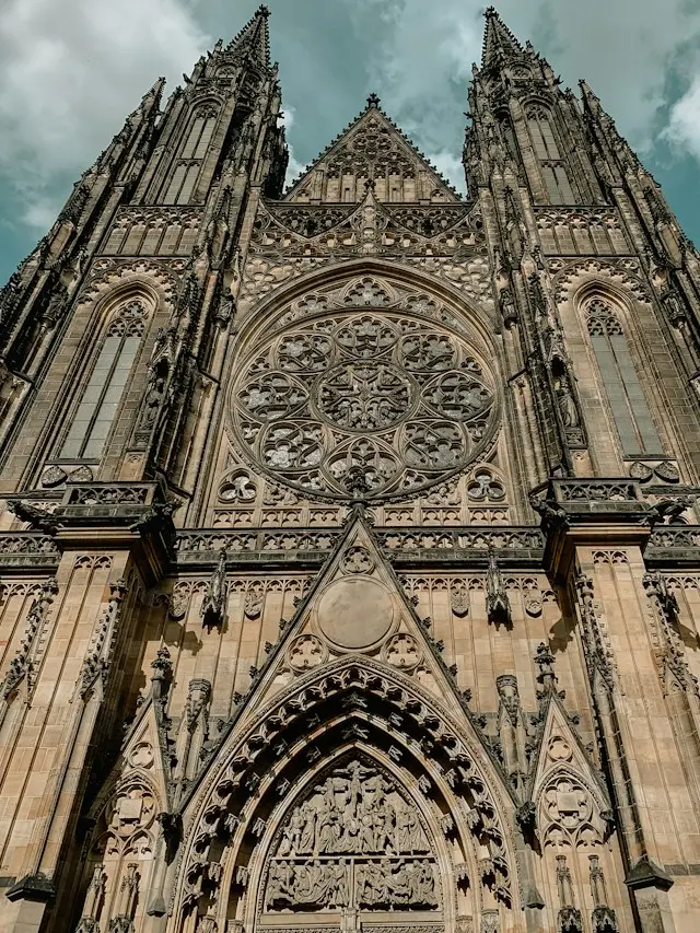 Gothic facade of St. Vitus Cathedral in Prague with its ornate rose window and twin towers.