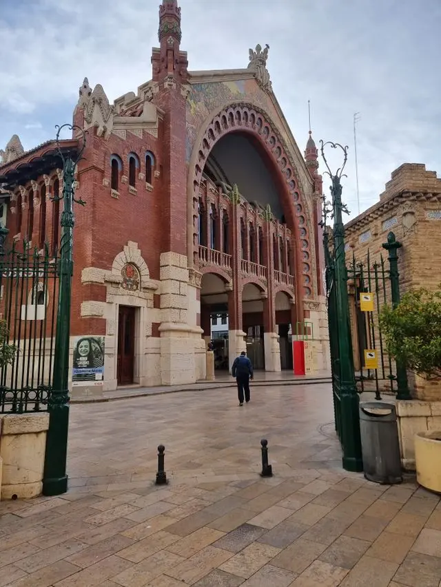 Valencia's Estació del Nord railway station featuring an ornate brick arch and historic architecture.