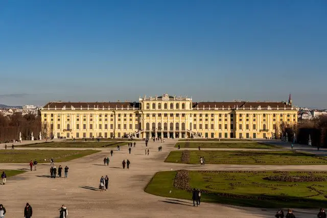 Schönbrunn Palace in Vienna with its grand yellow facade and expansive gardens.