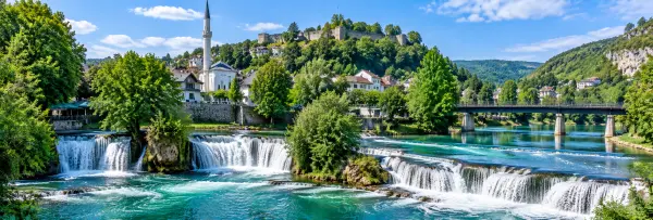 Bihać, Bosnia and Herzegovina, with turquoise waterfalls, historic buildings, a mosque, and a hilltop fortress