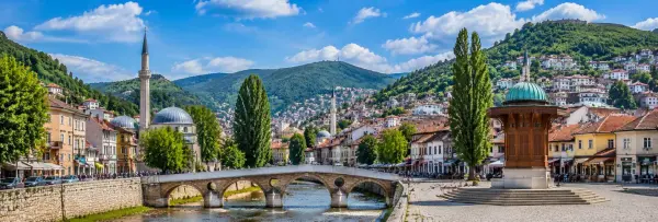Sarajevo Bosnia and Herzegovina cityscape with Baščaršija, Sebilj fountain and green hills
