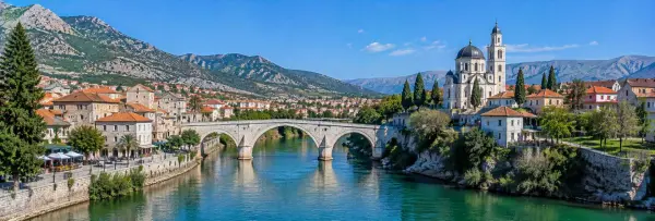 Trebinje with the Trebišnjica River, historic stone bridge, red roofs and surrounding mountains