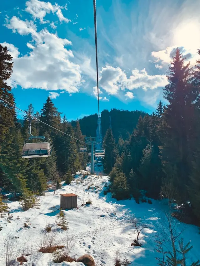 Gondola cable cars over a snowy forest in Bansko, Bulgaria
