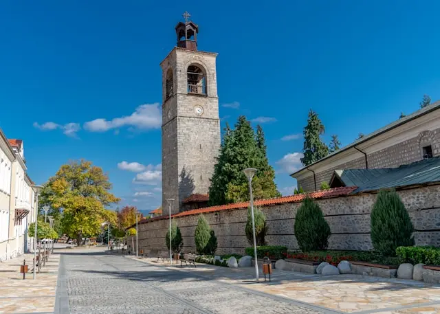 Historic church bell tower and stone street in Bansko, Bulgaria