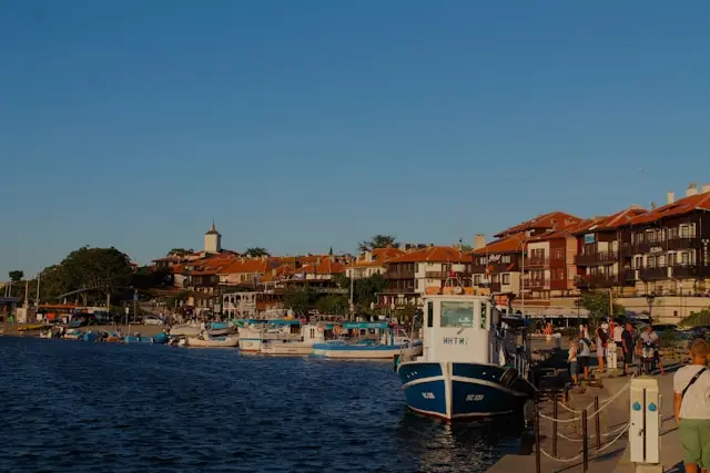 Nessebar waterfront with fishing boats and historic red-roofed buildings