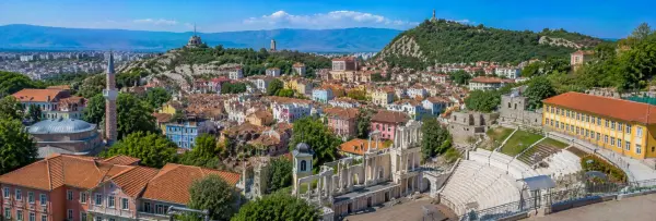 Plovdiv Old Town with colorful historic houses, Roman Ancient Theatre and green hills in Bulgaria.