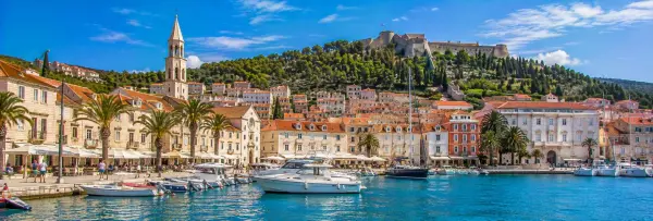 Hvar Croatia waterfront with historic Old Town, St Stephen's Cathedral and hilltop fortress