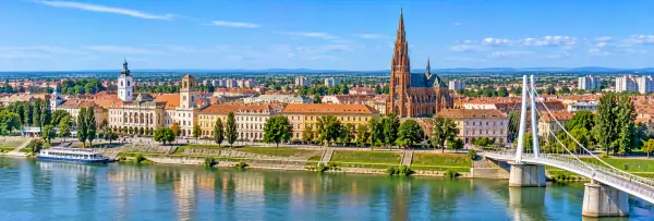 Panoramic view of Osijek, Croatia, with its historic center, red-brick co-cathedral, Drava River and pedestrian bridge.
