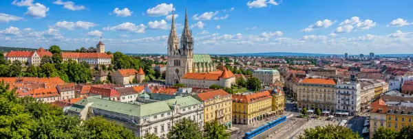 Zagreb Croatia cityscape with Zagreb Cathedral, historic rooftops and blue tram