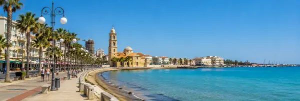 Larnaca, Cyprus waterfront promenade with palm trees, turquoise sea and historic seaside architecture