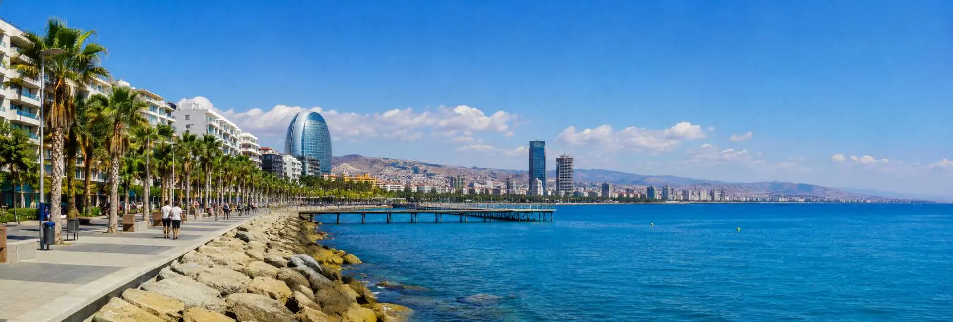 Limassol, Cyprus waterfront promenade with palm trees, turquoise Mediterranean Sea and modern skyline
