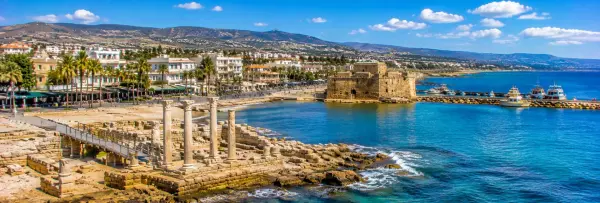 Paphos, Cyprus waterfront with ancient ruins, stone columns, harbor, and Mediterranean sea