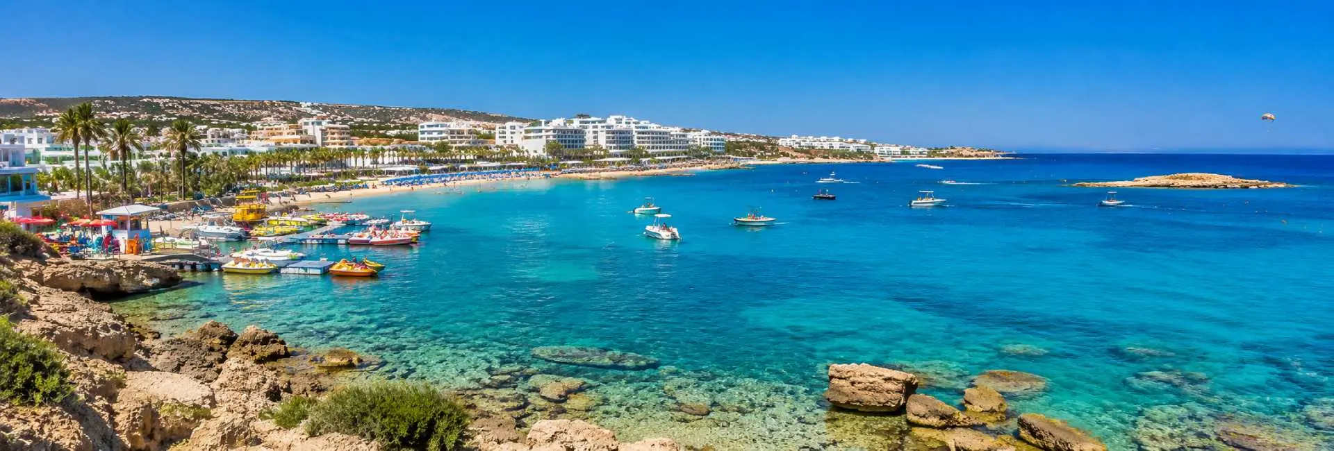 Protaras, Cyprus panoramic view of turquoise Mediterranean waters, sandy beach, boats and coastal resorts
