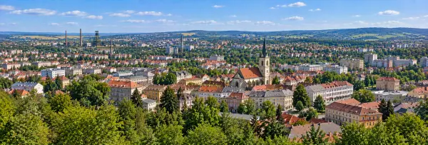 Panoramic view of Kladno with historic buildings, church spire, rooftops and former mining landscape