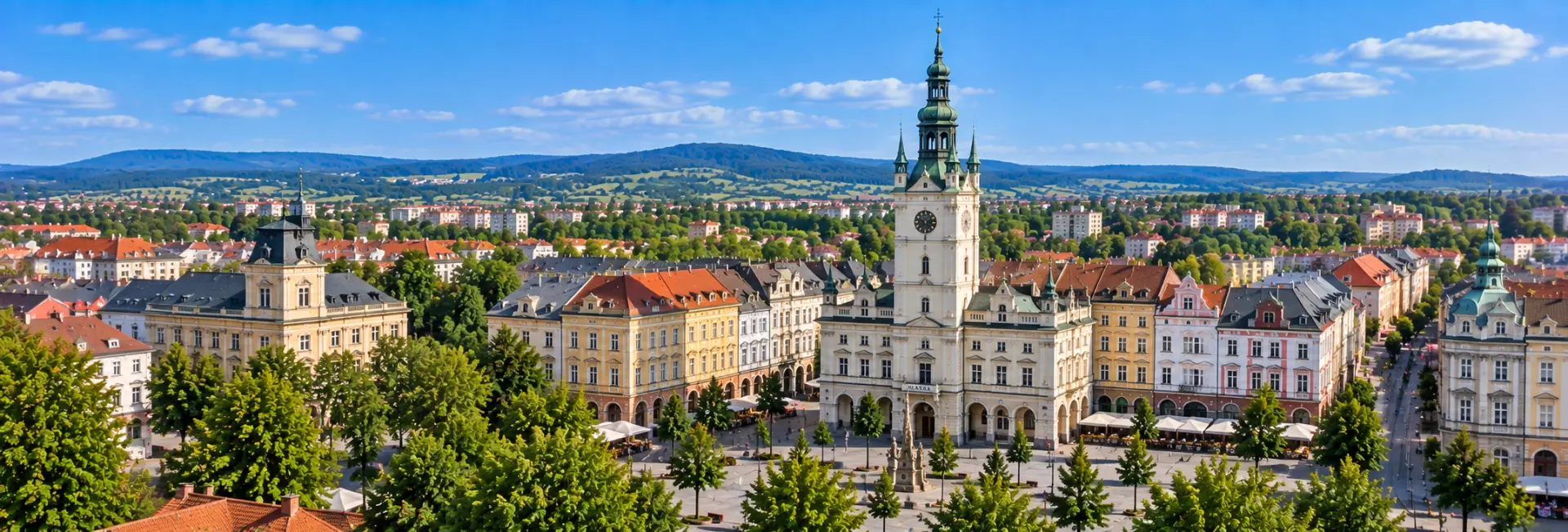 Panoramic view of Opava with Hláska tower, historic square, colorful buildings and surrounding hills