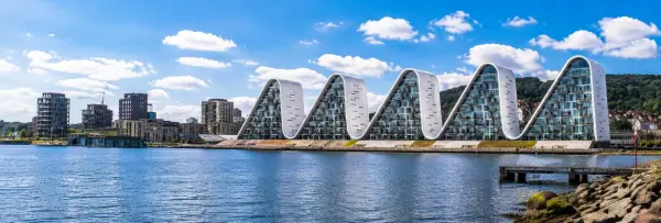 Bølgen waterfront buildings in Vejle, Denmark, overlooking the fjord under a bright blue sky