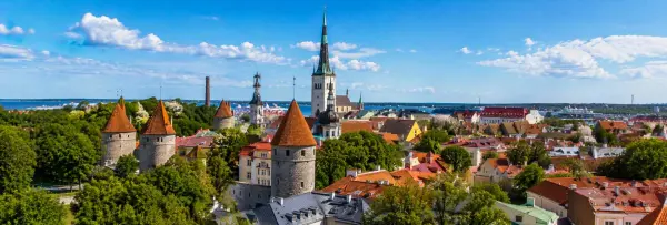 Tallinn Estonia Old Town with medieval towers, red rooftops and St. Olaf’s Church